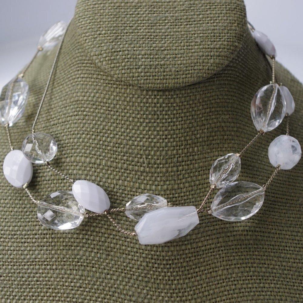 Women`s silver tone necklace with white and clear